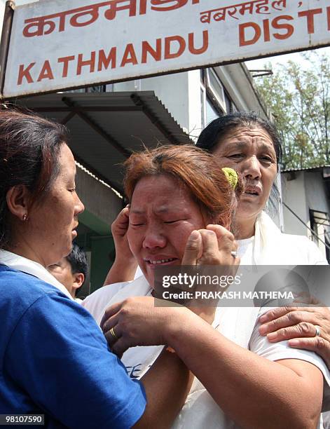 Tibetan in-exile breaks into tears after exiting the Kathmandu District Court following her release from a jail in Kathmandu on March 29, 2010. The...