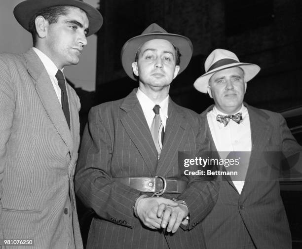 Accompanied by two deputy U.S. Marshals, Thomas Hasson and John J. Gericke , Harry Gold, confessed atomic spy, leaves New York's Federal Court for a...