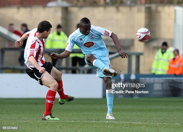 Abdul Osman of Northampton Town plays the ball watched by Richard Butcher of Lincoln City during the Coca Cola League Two Match between Lincoln City...