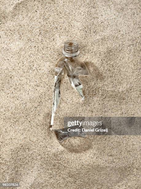 plastic bottle buried in sand - västra götalands län stockfoto's en -beelden