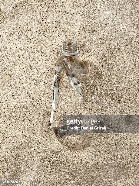 plastic bottle buried in sand - västra götaland county stock pictures, royalty-free photos & images