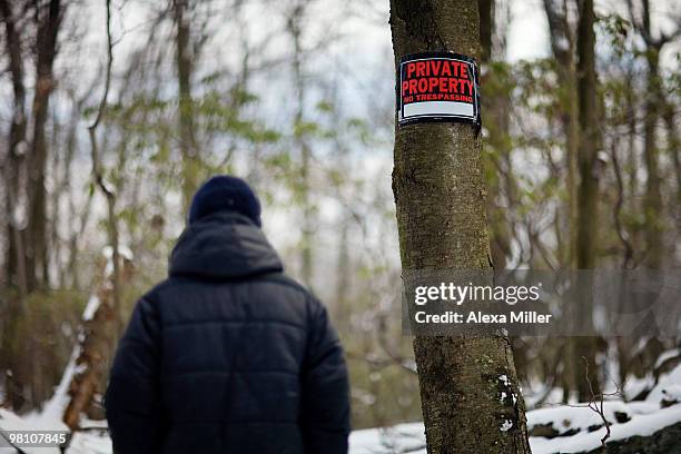 man walking past private property sign. - private property stock pictures, royalty-free photos & images