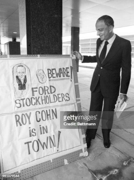 Roy Cohn, a New York attorney involved in a Ford Motor Co., stockholders suit, stops to admire a sign outside the Ford Auditorium where the Ford...