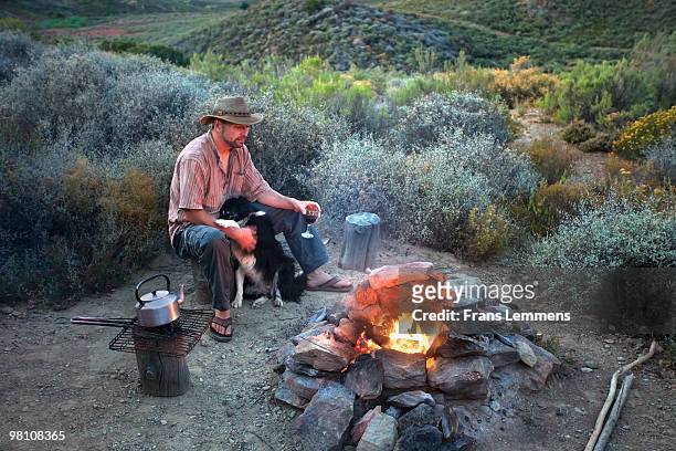 south africa, simonskloof, relaxing near campfire - moving down to seated position stock pictures, royalty-free photos & images