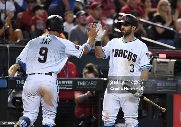 Daniel Descalso of the Arizona Diamondbacks congratulates Jon Jay for scoring a run against the New York Mets at Chase Field on June 17, 2018 in...