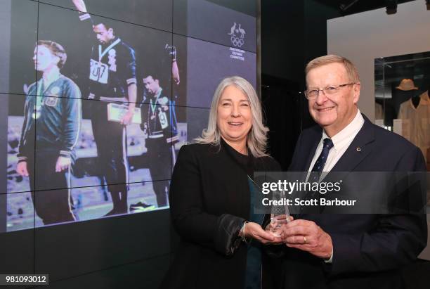 The family of the late Olympian Peter Norman, represented by his daughter Janita Norman, poses with AOC President John Coates during a posthumous...