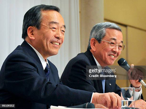 Takeshi Uchiyaimada, executive vice president of Toyota Motor Corp., left, and Masaharu Yamaki, vice president of Mazda Motor Corp., smile together...