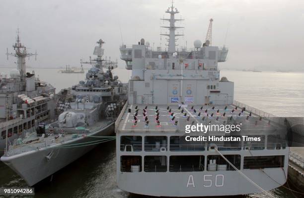 Indian Navy officials perform yoga on the flight deck of Indian Navy's decommissioned aircraft carrier 'Viraat' on the occasion of World Yoga day, on...