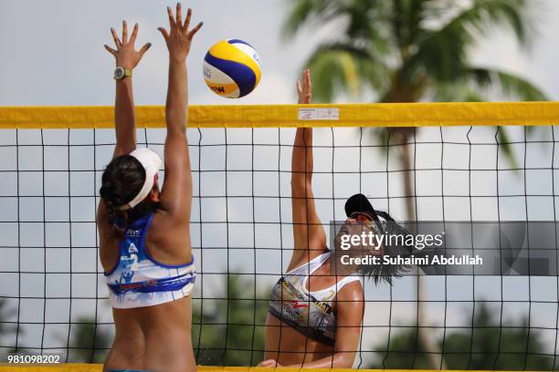Kaho Sakaguchi of Japan attempts to block Ayumi Kusano of Japan spikes during the main draw pool E women's match on day one of the FIVB Beach...