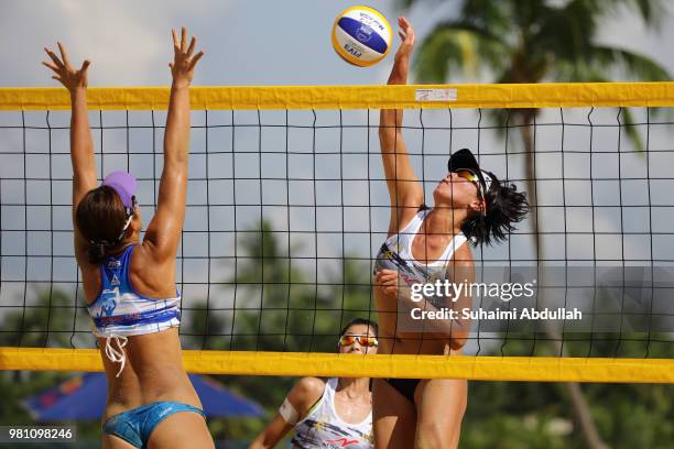 Yukano Suzuki of Japan attempts to block Ayumi Kusano of Japan spikes during the main draw pool E women's match on day one of the FIVB Beach...