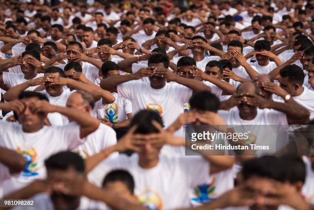 People perform yoga on the occasion of World Yoga day at Gateway of India, on June 21, 2018 in Mumbai, India. The first International Yoga Day was...