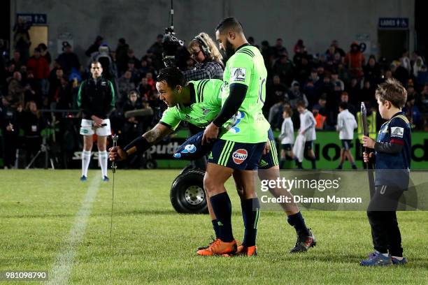 Co Captains Ash Dixon and Lima Sopoaga of the Highlanders present a metal claymore to the Barbarians prior to the match between the Highlanders and...