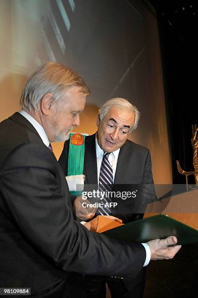 French Managing Director of the International Monetary Fund Dominique Strauss-Kahn receives his honorary degree from Bernard Rentier , chief...