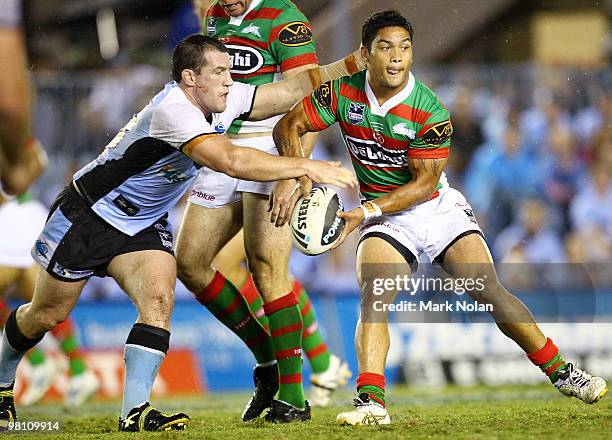 Paul Gallen of the Sharks tackles Issac Luke of the Rabbitohs during the round three NRL match between the Cronulla Sharks and the South Sydney...