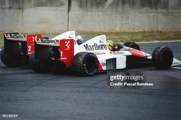 Alain Prost driving the Marlboro McLaren-Honda MP4/5 controversially collides with his team mate Ayrton Senna during the Japanese Grand Prix on 22...