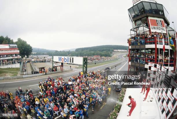 Ayrton Senna, driver of the Marlboro McLaren-Honda MP4/5 celebrates by spraying champagne with second placed team mate Alain Prost and third placed...