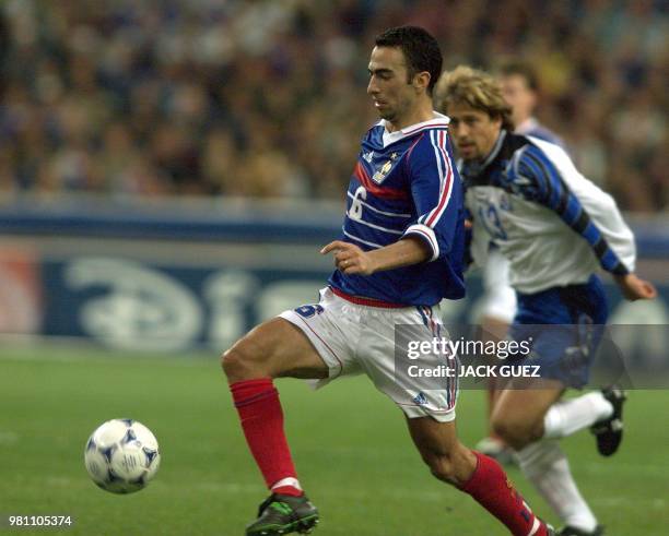 France's Youri Djorkaeff escapes with the ball in front of Iceland's Helgi Kolvidsson during their Euro-2000 qualifying match at the Stade de France...