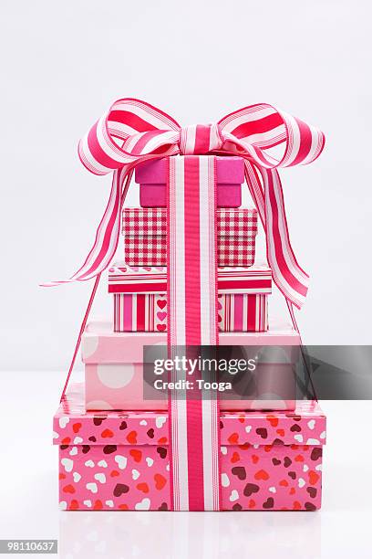 stack of pink presents with bow - pile of gifts stock pictures, royalty-free photos & images