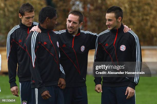 Franck Ribery talks to his team mates David Alaba and Diego Contento during the Bayern Muenchen training session at Bayern's training ground...