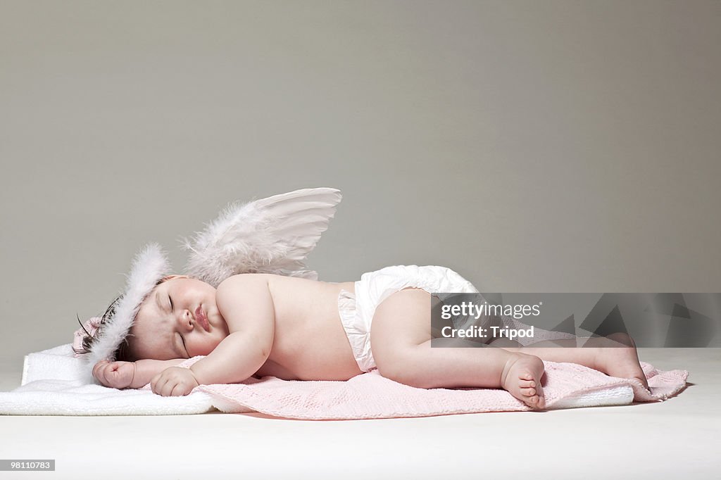 Baby girl angel sleeping on blanket