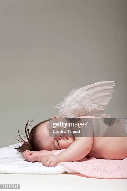 baby girl angel sleeping on blanket - baby angel wings stock pictures, royalty-free photos & images