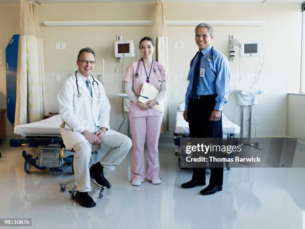 portrait of medical team in emergency room - doctor sitting stock pictures, royalty-free photos & images