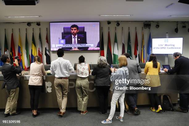 Journalists listen to the opening remarks as Suhail Mohammed Al Mazrouei, United Arab Emirates' energy minister, appears on a screen, in the press...