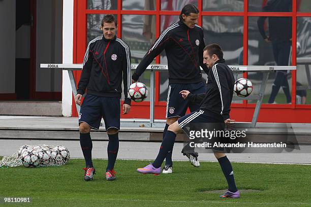 Mirolsav Klose , Daniel van Buyten and Franck Ribery play with the ball during the Bayern Muenchen training session at Bayern's training ground...