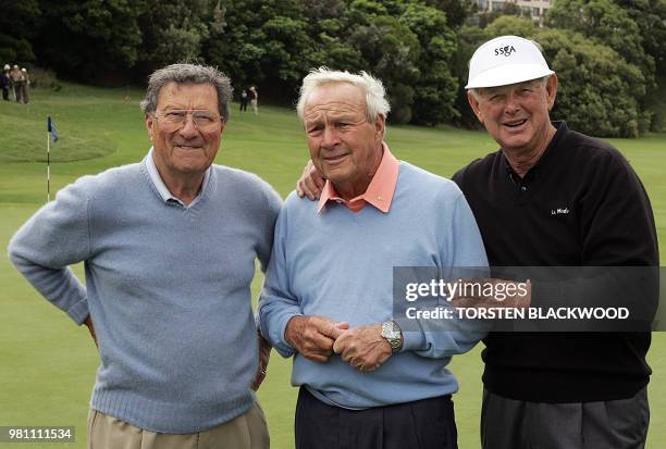 American golfing icon Arnold Palmer is embraced by Australian greats Bruce Devlin and Peter Thomson at the conclusion of a nine-hole exhibition game...