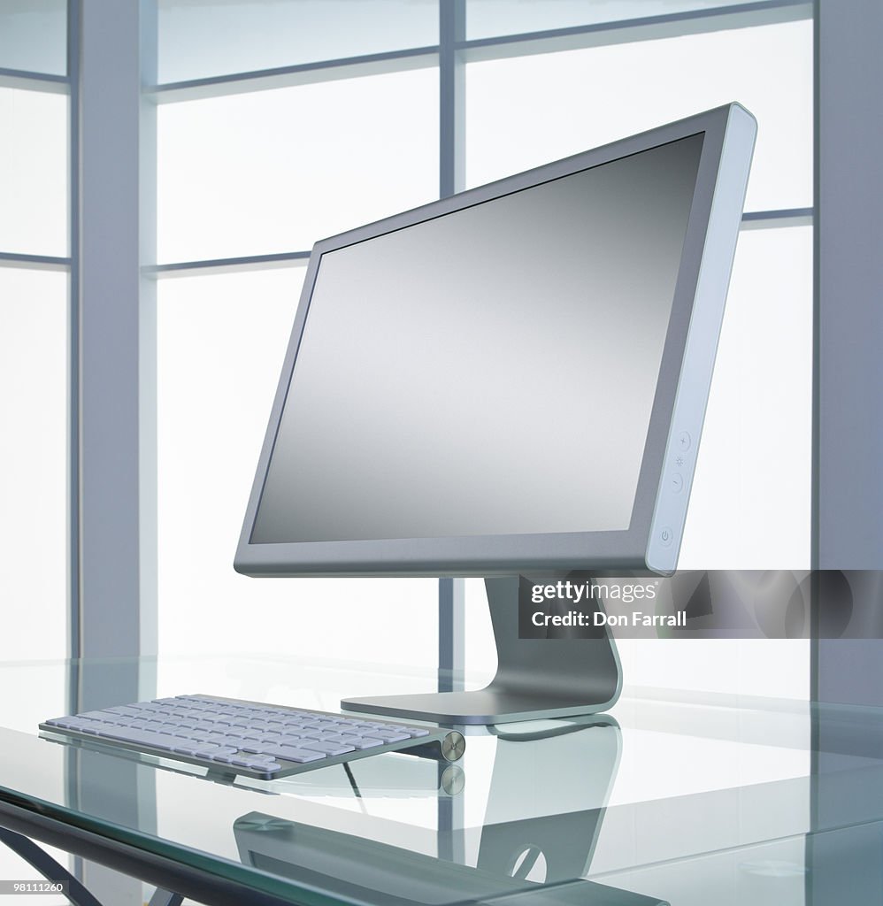 Computer on a glass desk