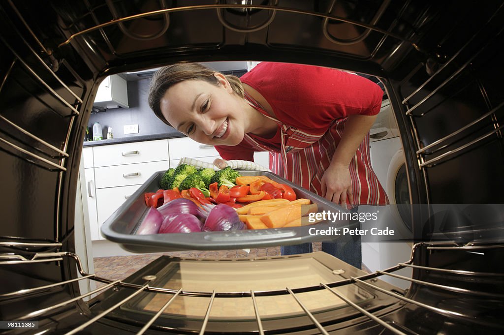 Putting vegetables into oven