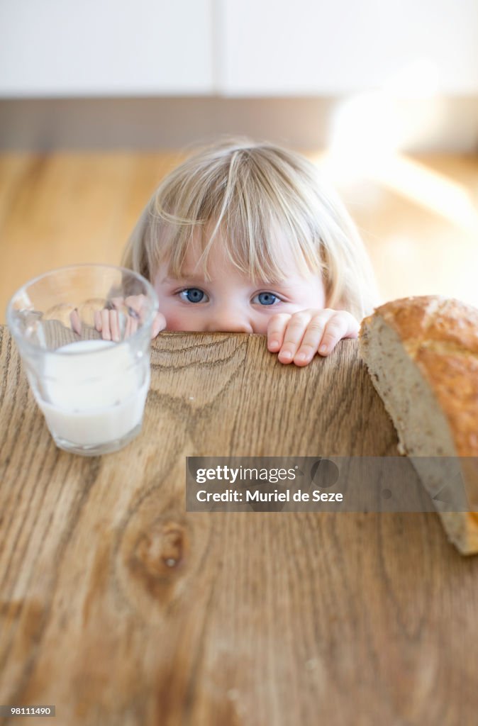 Girl hidding behind wooden table