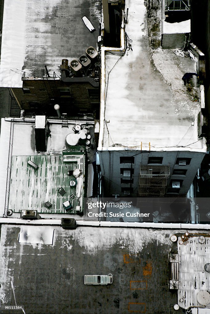 Looking down on snowy city rooftops