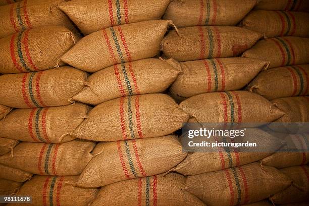 stack of raw coffee bean jute sacks - fair trade stock-fotos und bilder