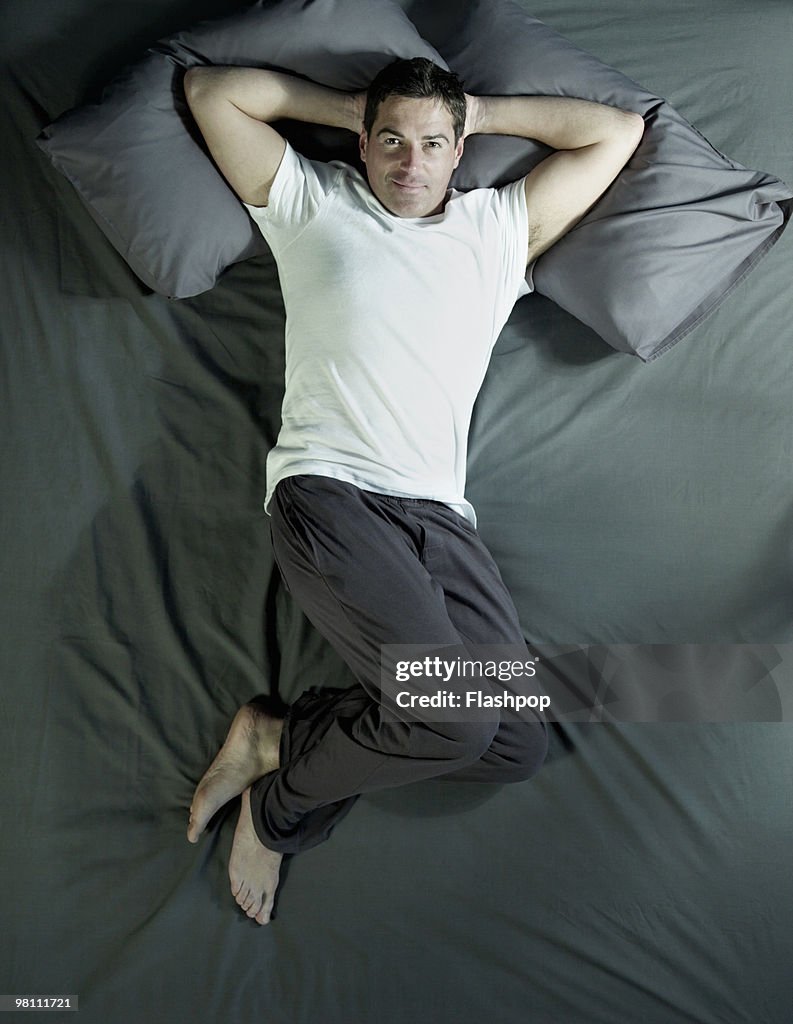 Aerial view of man lying on bed