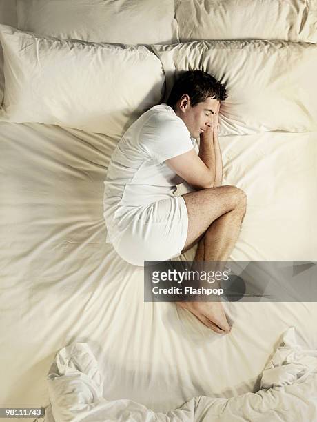 man sleeping - above view of man sleeping on bed stock pictures, royalty-free photos & images