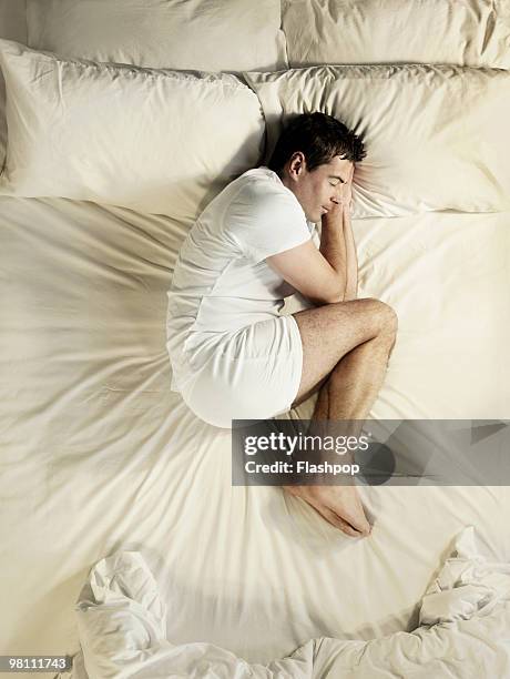 man sleeping - hugging knees bildbanksfoton och bilder