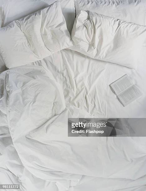 still life of a book opened on a bed - bedding stock pictures, royalty-free photos & images