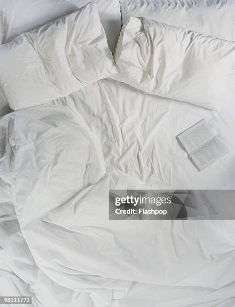 still life of a book opened on a bed - bedclothes - fotografias e filmes do acervo