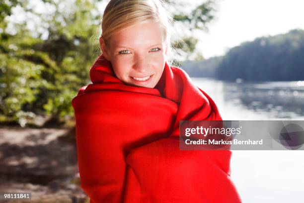 woman warming under blanket in the morning - red blanket stock pictures, royalty-free photos & images