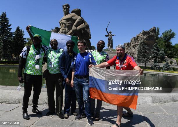 Supporters of the Nigerian national football team pose with Russian fans while visiting the Mamayev Kurgan World War Two memorial complex in...