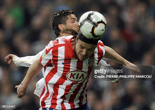 Real Madrid's Portuguese forward Cristiano Ronaldo vies with Atletico Madrid's Czech defender Tomas Ujfalusi during their Spanish League football...