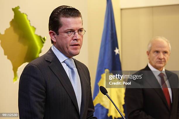 German Defense Minister Karl-Theodor zu Guttenberg speaks next to Kosovan President Fatmir Sejdiu in front of a Kosovan relief during a press...