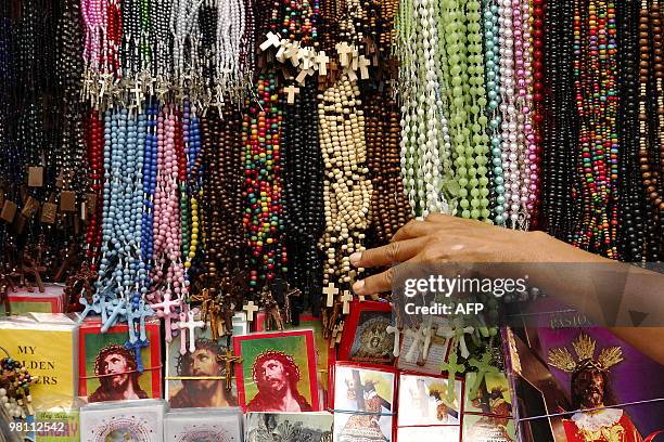 Filipino vendor arranges Christian rosaries for sale near the Quiapo church in Manila on March 29, 2010. The Philippines is Asia's bastion of...
