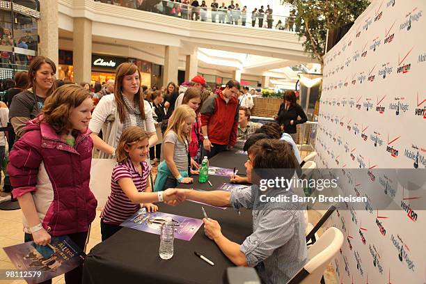 Zach Porter, Michael Martinez, Nathan Darmody and Cameron Quiseng of Allstar Weekend sign autographs for fans at Verizon's ''Experience the Magic''...