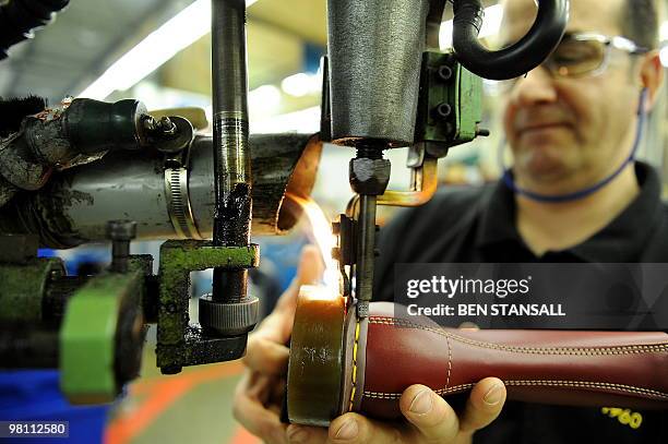 Dr Martens employee heat seals boot soles in the Dr Martens factory in Wellingborough, Northamptonshire, in central England, on March 18, 2010. What...