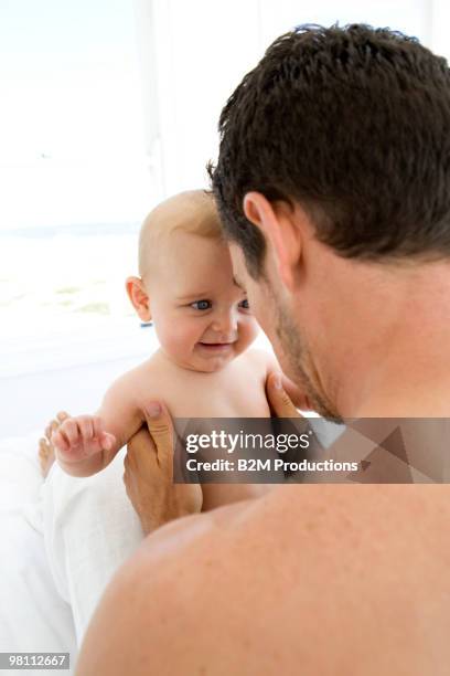 baby and father face to face - baby face stock pictures, royalty-free photos & images