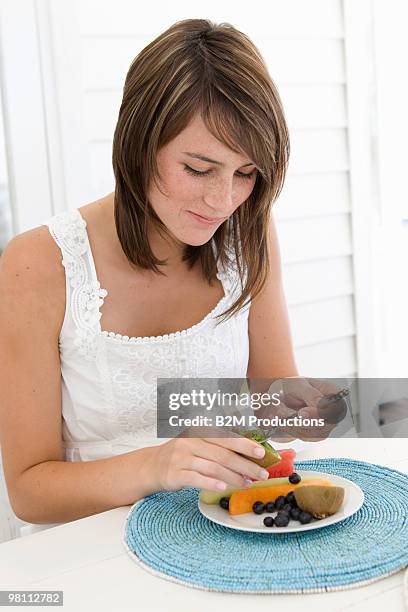 young woman eating fruits - woman smiling facing down stock pictures, royalty-free photos & images