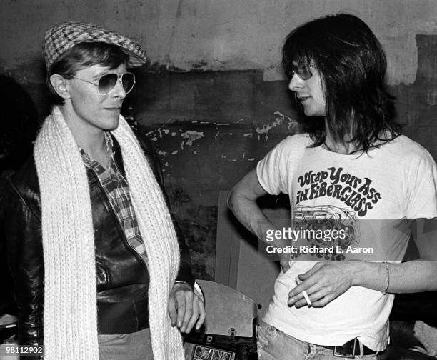 David Bowie poses with Lenny Kaye, from the Patti Smith Group, at CBGB's club in New York City on April 04 1975