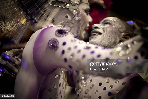 Revellers of the Mocidade Alegre samba school cheer at the Sambadrome, as part of Carnival celebrations in Sao Paulo, Brazil, early on February 14,...